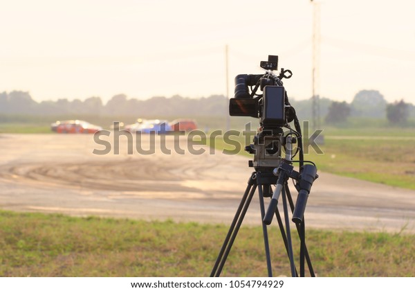 Video camera\
operator working at the race track\
