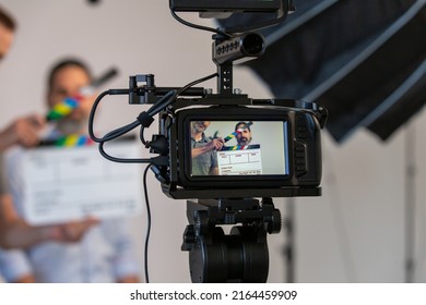 Video Camera and Video Production Studio Set. Actor, Slate Can Be Seen Through Monitor With Blurry Background