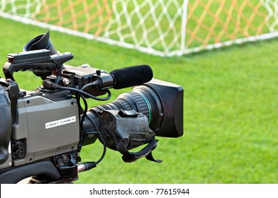 Video Camera Put On The Back Of Football Goal For Broadcast On TV Sport Channel. Football Program Can't Editing In Studio. Camera Man  Is Importance To Catch Moment Of Player.