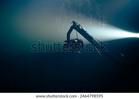 Video camera silhouette in dark blue banner with light, movie or television background, Recording video at studio. Camera records or filming for cinema. Behind the scenes of filming video production.