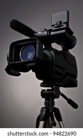 Video Camera And Tripod On Gray Background