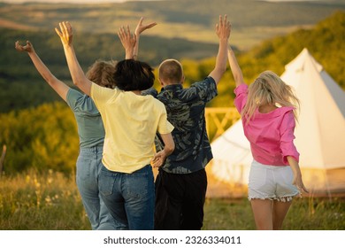 Video capturing group of friends meeting at the campsite in the middle of nature beside the big tent hugging each other and start to discussing - Powered by Shutterstock