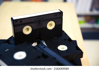 Video Cassette Tapes VHS In The Video Tape Player And Pile Stack Concept Of Old Retro Style Or Vintage Electric And Electronic Appliances Multimedia Record Playback Device Old Fashioned.