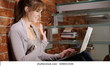 Video Chat With Friends By Young Woman, Sitting On Stairs