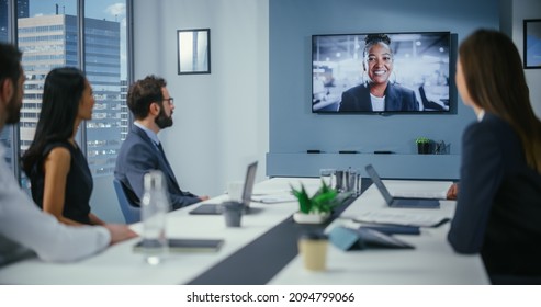 Video Conference Call In Office Boardroom Meeting Room: Black Female Executive Director Talks With Group Of Entrepreneurs, Managers, Investors. Businesspeople Discuss E-Commerce Investment Strategy