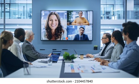 Video Conference Call in Office Boardroom Meeting Room: Executive Directors Talk with Group of Multi-Ethnic Entrepreneurs, Managers, Investors. Businesspeople Discuss e-Commerce Investment Strategy