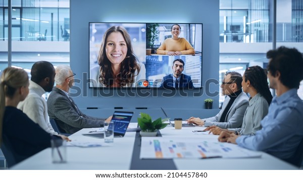 Video Conference Call in Office Boardroom\
Meeting Room: Executive Directors Talk with Group of Multi-Ethnic\
Entrepreneurs, Managers, Investors. Businesspeople Discuss\
e-Commerce Investment\
Strategy