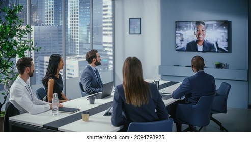 Video Conference Call In Office Meeting Room: Black Female Executive Talks With Group Of Multi-Ethnic Digital Entrepreneurs, Managers, Investors. Businesspeople Discuss E-Commerce Investment Strategy