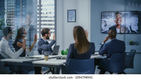 Video Conference Call in Office Meeting Room: Black Female Executive Talks with Group of Multi-Ethnic Digital Entrepreneurs, Managers, Investors. Businesspeople Discuss e-Commerce Investment Strategy - Powered by Shutterstock