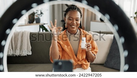 Video, content creator and black woman doing skincare for tutorial on social media or the internet. Dermatology, happy and African female influencer filming or live streaming face routine at home.