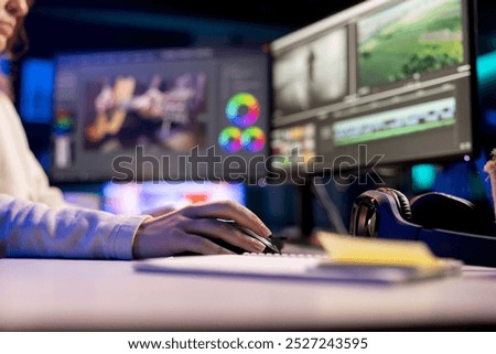 Video editor selecting key frames to use while doing video montage, using specialized software applications. Freelancer using editing tools on computer to cut movie project footage in office, close up