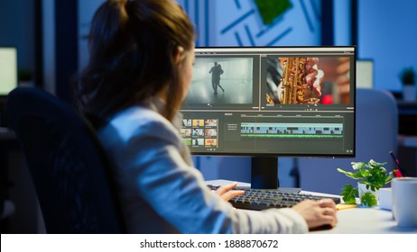 Video editor working at night at new project editing audio film montage sitting in start-up business office. Woman content creator using professional computer, modern technology, network wireless - Shutterstock ID 1888870672