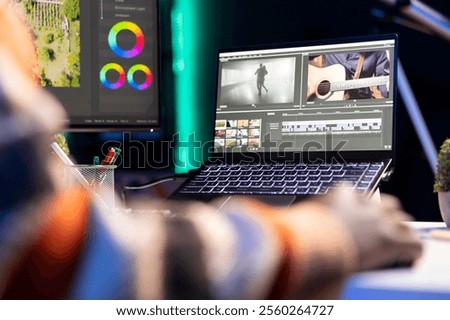 Video editor working on creative software to create a film montage, using color correction wheel and adding visual effects. Male creator editing gradient for movie post production, white balance.