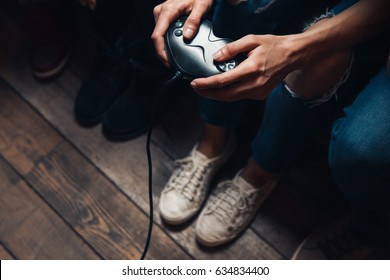 Video game addiction, psychological disorder excessive play, everyday unhealthy lifestyle. Closeup view of unrecognizable person hands with joystick. - Powered by Shutterstock