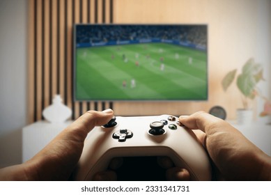 Video game controller, gaming concept with TV screen in background