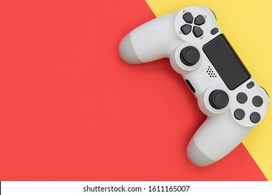 Video Game Gaming Controller On Bright Red Yellow Color Background Top View