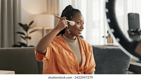 Video, influencer and black woman doing makeup for tutorial on social media or the internet. Cosmetic, happy and young African female person filming or live streaming face cosmetology routine at home - Powered by Shutterstock