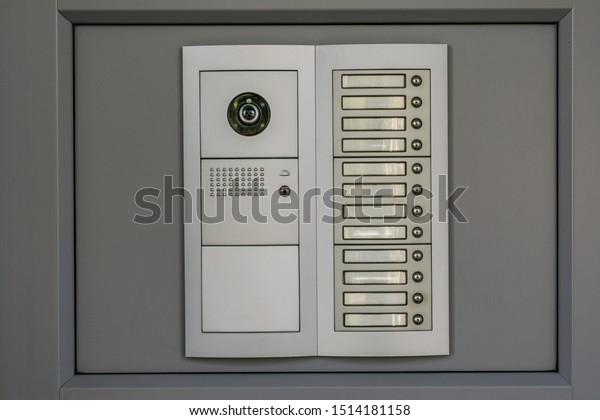 Video intercom system on grey background at\
residential or office building.\
