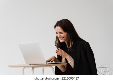 Video Meeting With Friends And Colleagues And Have Fun Online Remotely After Successful Project. Girl With Laptop Smile, Laughs And Discussing Funny Situations At Work With Colleagues