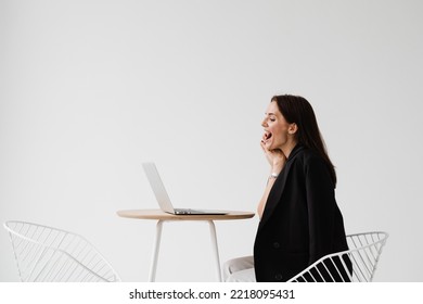 Video Meeting With Friends And Colleagues And Have Fun Online Remotely After Successful Project. Girl With Laptop Smile, Laughs And Discussing Funny Situations At Work With Colleagues