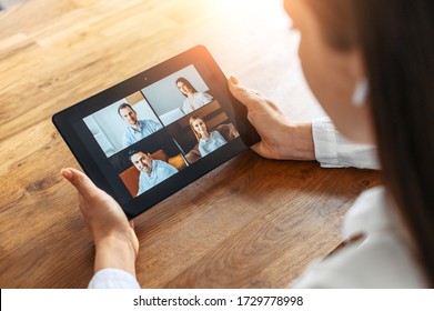 Video Meeting. A Woman In Formal White Shirt Is Using A Digital Tablet For Video Connection, Video Call In The Office. Online Conference With Several People Together