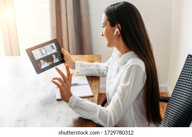 Video Meeting. A Woman In Formal White Shirt Is Using A Digital Tablet For Video Connection, Video Call In The Office. Online Conference With Several People Together