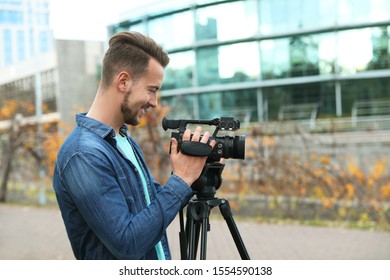 Video operator with camera working on city street