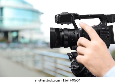 Video operator with camera working on city street, closeup - Shutterstock ID 1564740634