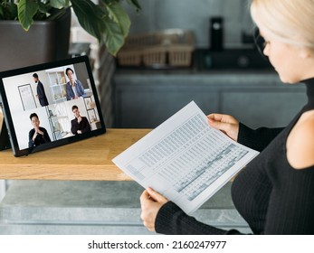 Video Presentation. Global Telecommuting. Woman Using Tablet Working From Home Discussing Financial Statistics Report Online With Diverse Business Team On Screen.