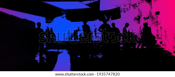 Video production behind the scenes or the making
of movie and film crew team working in silhouette of camera and
equipment set in studio. Online video shooting process. film
industry concept.