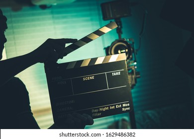 Video Production Theme. Caucasian Film Industry Worker with Clapperboard in Hands. 