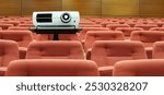 Video projector among empty seats in lecture room concept photo. Lecturer space scene