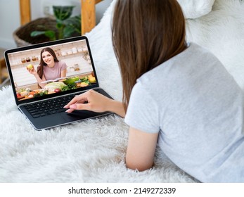 Video Recipe. Online Culinary Class. Homemade Food Tutorial. Healthy Nutrition Virtual Course. Woman Watching Female Chef Cooking Vegetarian Meal On Laptop Screen At Home.