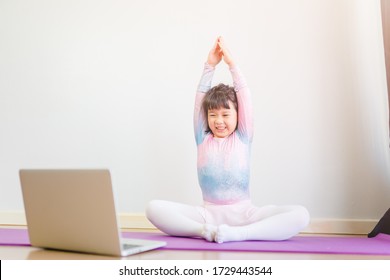 Video Streaming Stay Fit At Home.home Fitness Workout Class Live Streaming Online.Asian Kid Girl In Yoga Gymnastics Keep Calm And Fit.Online Class Live Videos On Laptop At Home.New Normal Healthcare.