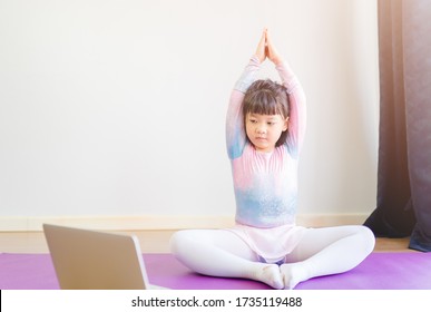 Video Streaming Stay Fit At Home.home Fitness Workout Class Live Streaming Online.Asian Kid Girl In Yoga Gymnastics Keep Calm And Fit.Online Class Live Videos On Laptop At Home.New Normal Healthcare.