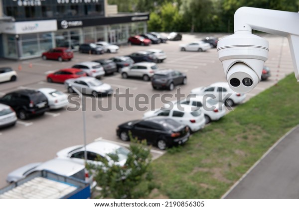 Video\
surveillance camera installed on a vehicle\
parking.