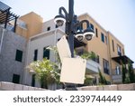 Video surveillance cameras at the post. Modern external video surveillance system in the recreational and residential area of the Mediterranean city. Cameras is attached to a street pole.