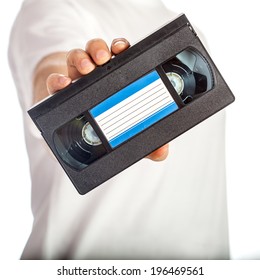 Video Tape Cassette (VHS) With Blue Label Hold By Male Hand