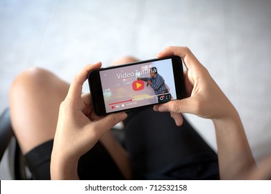 video tutorial concept Female hands holding mobile phone