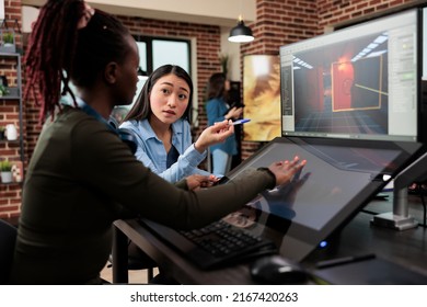 Videogame Developing Company Employees Working On Alpha Build Of 3D Game Project While Sitting At Desk. Production Department Diverse Team Members Optimising Digital Product Using Modern Software.