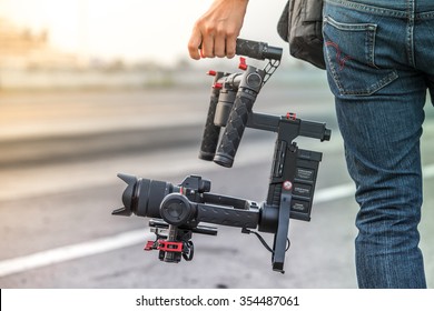 Videographer with gimbal video camera dslr, Professional video equipment, Videographer in event film production shoot video.