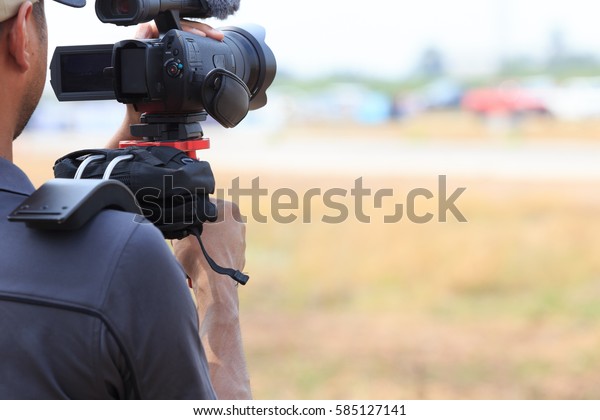 Videographer with gimball video camera dslr,\
Professional video equipment, Videographer in event film production\
shoot video.