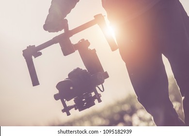 Videographer with Professional Gimbal Video Camera Stabilizing Equipment. 