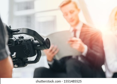 Videographer professional shooting record video usign gimbal camera stabilizer for anti shake device technology in businessman scene.