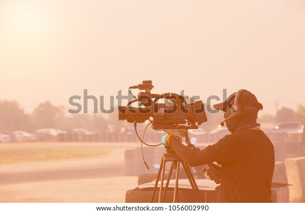 videographer staff
Prepare Photographer video recording activity with in the event
racing track and evening
scene
