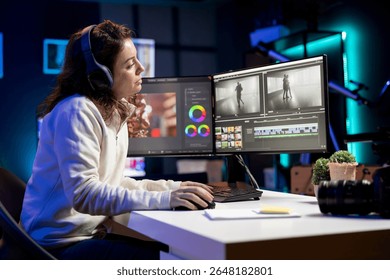 Videographer uses software to create visual effects for video projects while relaxing with some music. Professional wearing headphones using post production techniques to edit raw footage