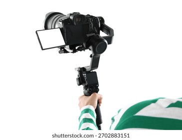 Videographer using gimbal stabilizer with camera on white background, closeup