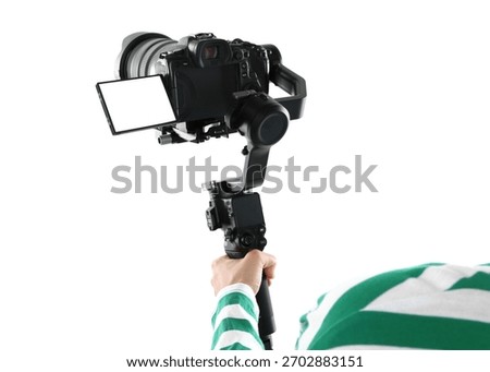 Videographer using gimbal stabilizer with camera on white background, closeup