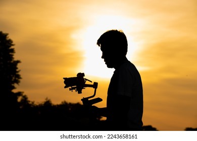 Videographer's shadow behind at sunset