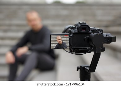 Videography And Blogging Concept - Handsome Male Blogger Recording Video With Modern Dslr Camera